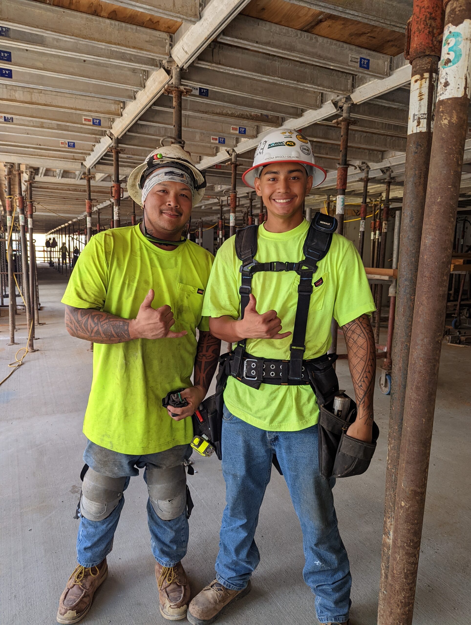 A summer intern and his site supervise show shakas and big smiles on-the-job.