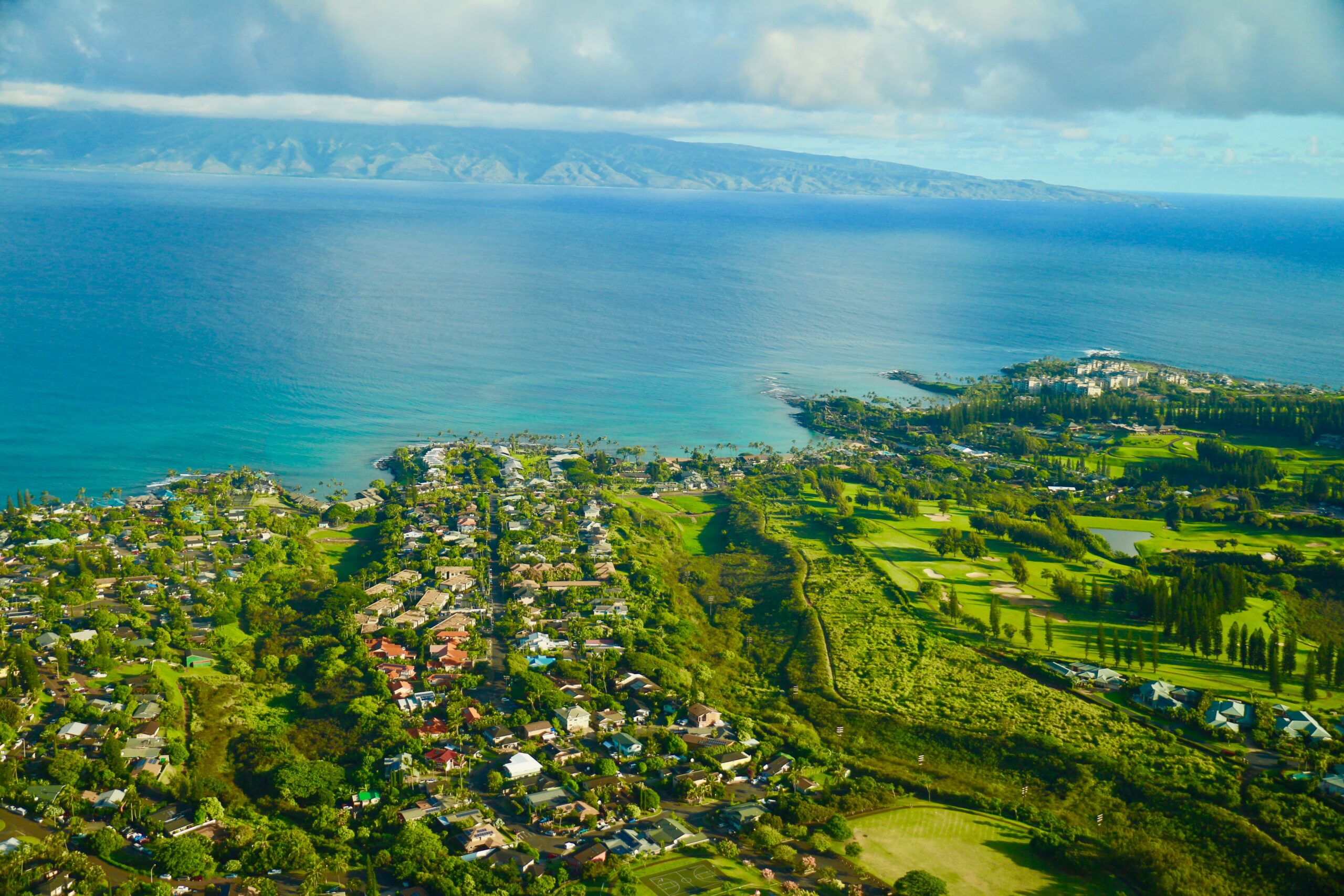 Overhead shot of Maui's landscape, including land and ocean.