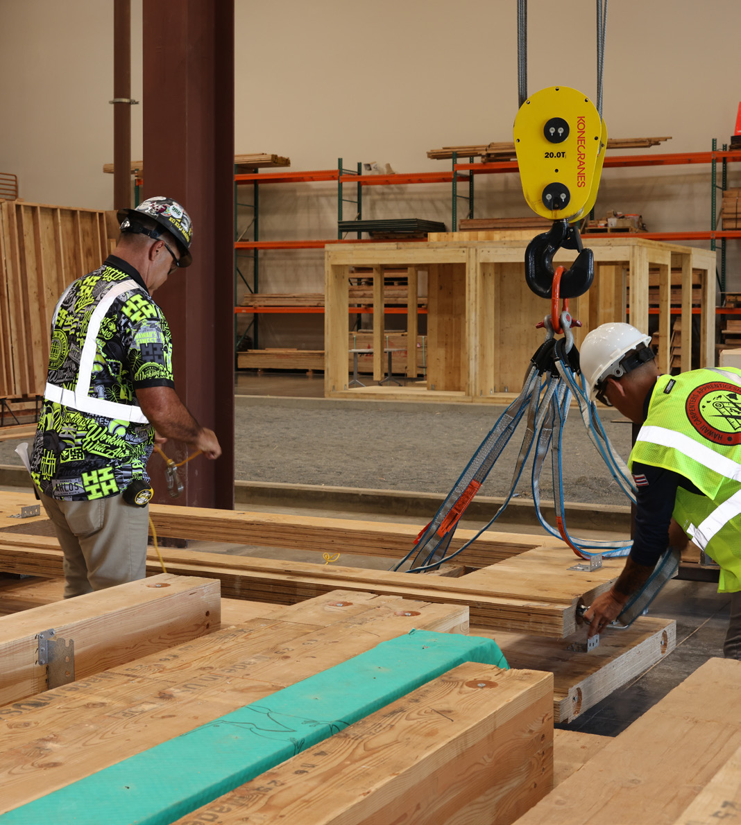 Carpenters practice handling mass timber components during hands-on training.